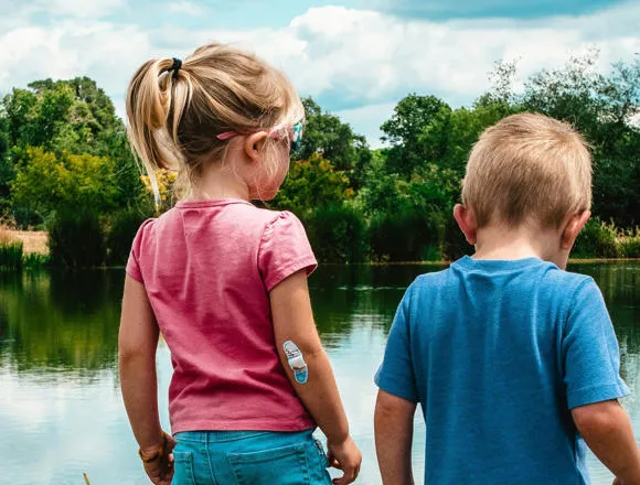 Two children by a pond